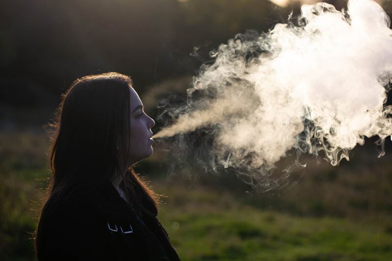 woman vaping during the early morning